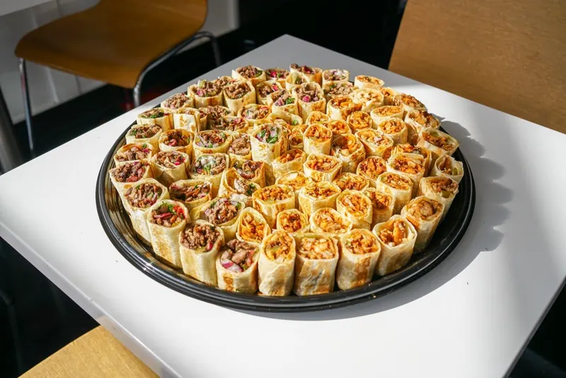 A round tray of beef and chicken shawarma bites